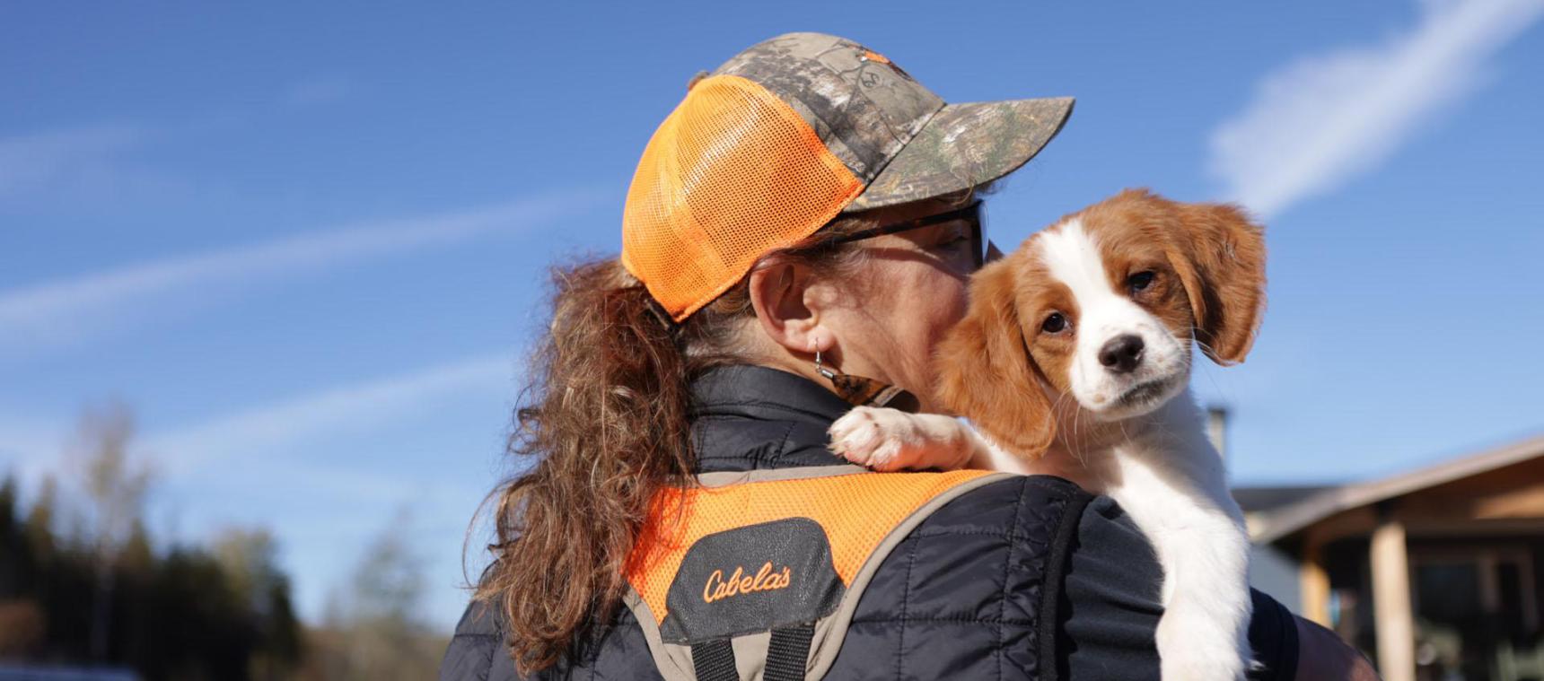 kelly holding her puppy outside