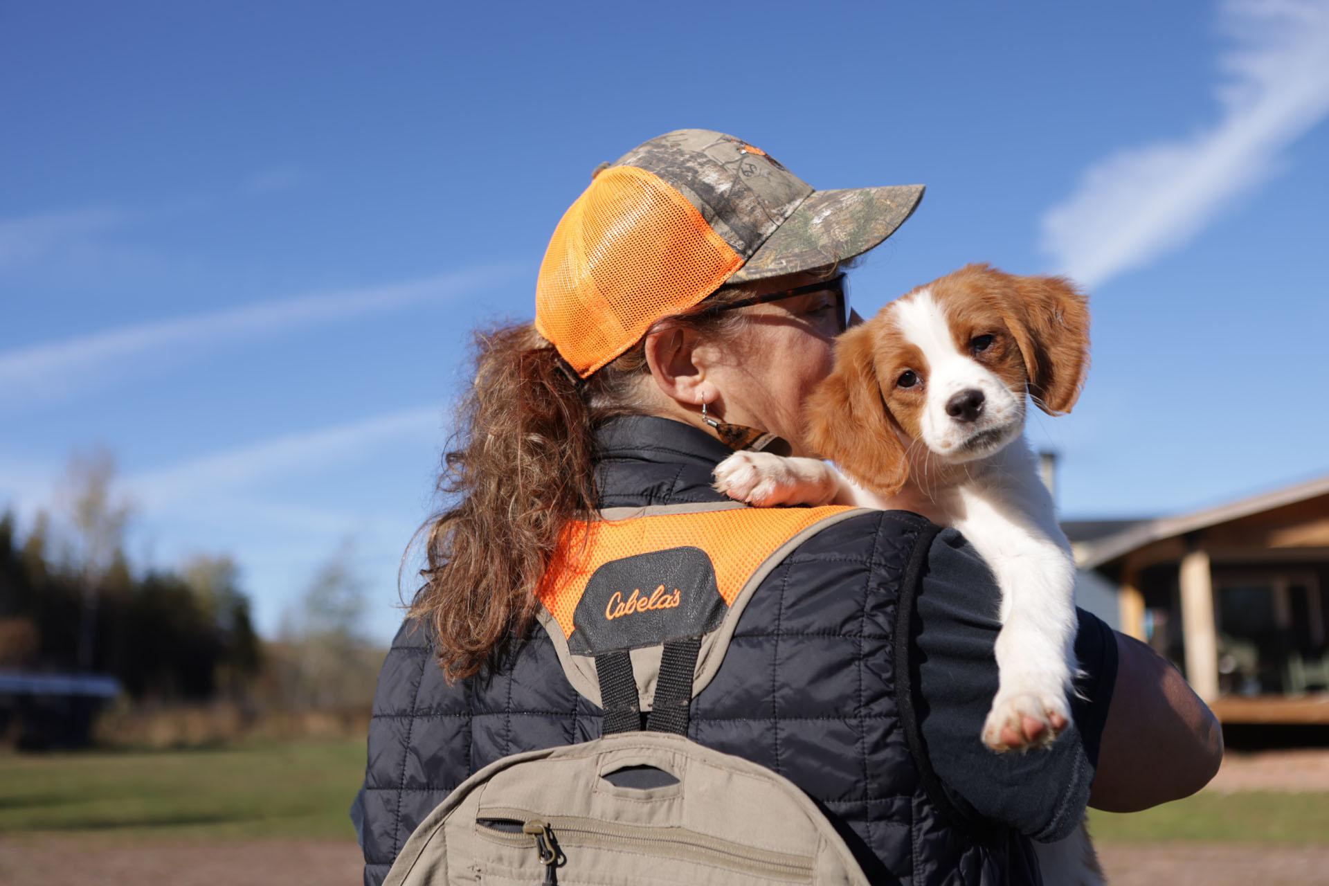 kelly holding her puppy outside